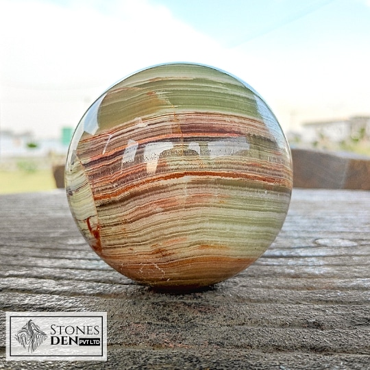 big size multi green onyx ball placed outside